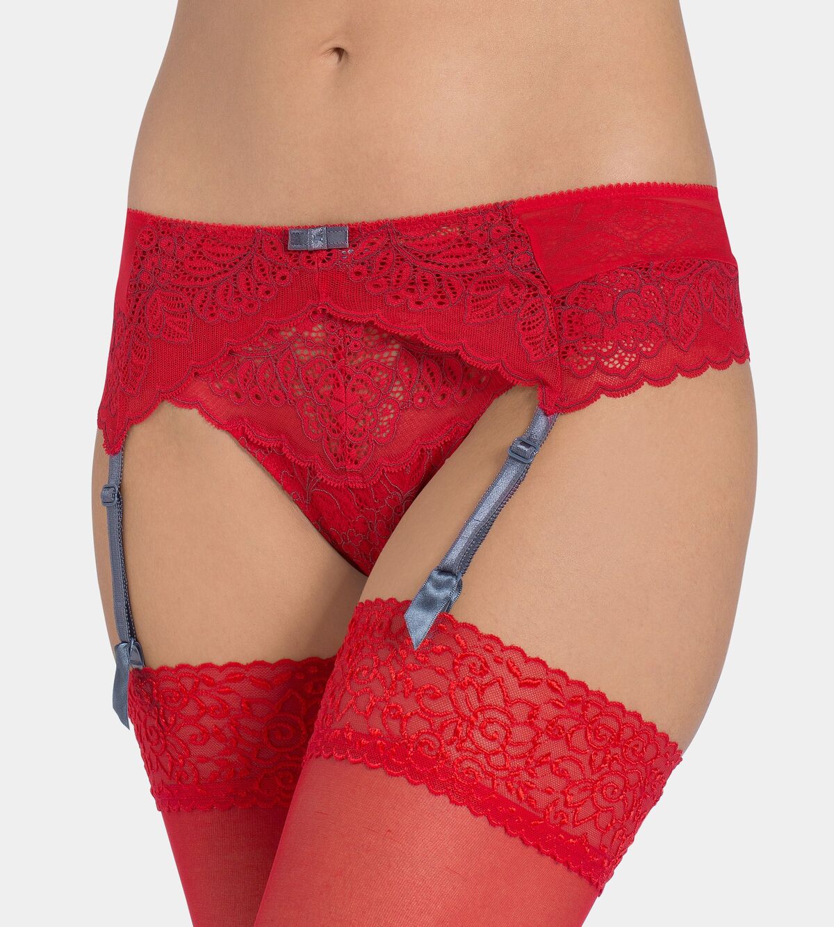 Triumph Amourette Spotlight garter belt in red model close-up view, showing details of graphical floral lace and four adjustable suspender straps. Now Available Online