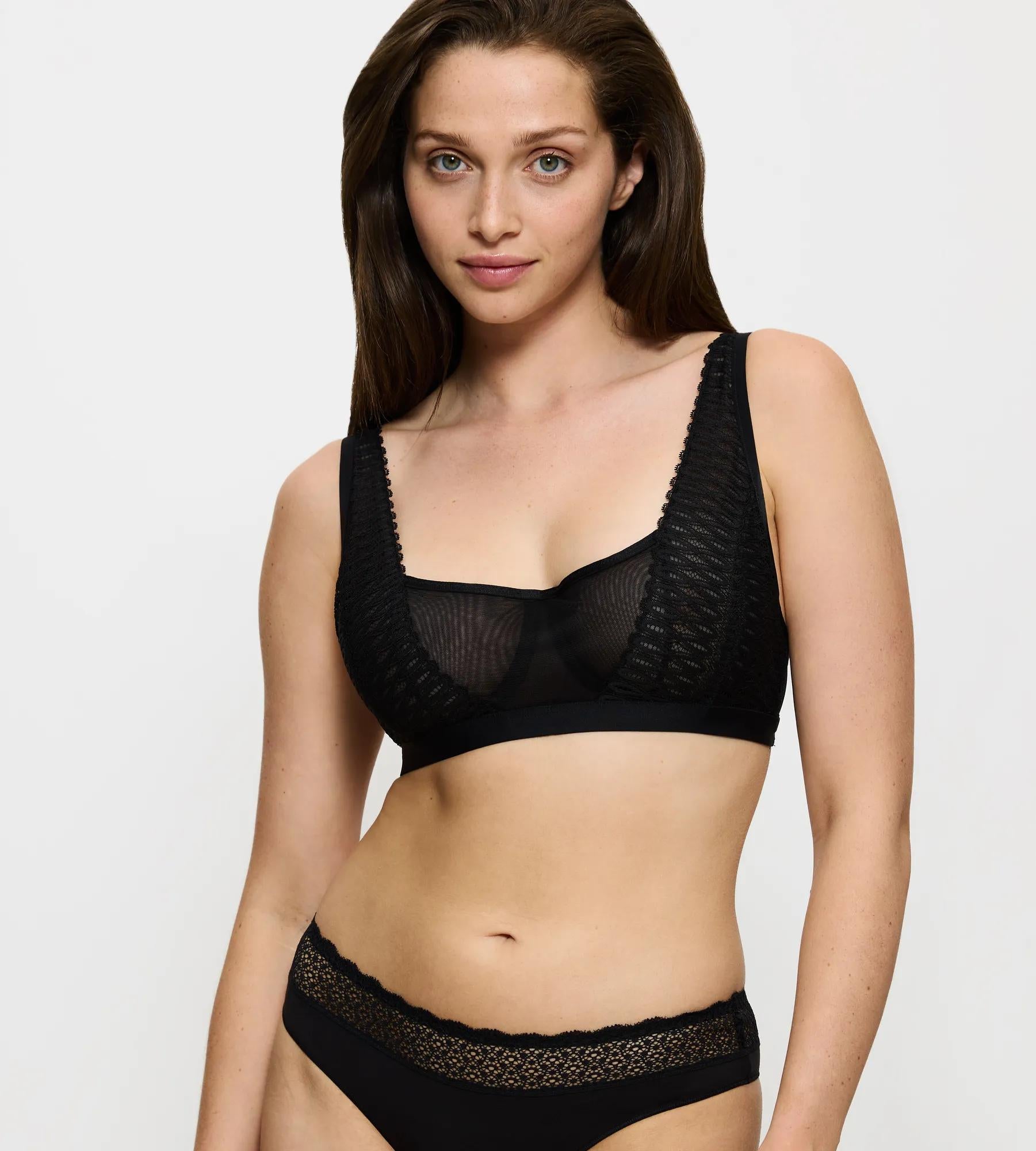Triumph Aura Spotlight black wired bra model front view, highlighting the non-padded lace cups and supportive underwire design. Find Online Today