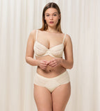 Triumph Aura Spotlight maxi panty in light beige model full front view, showing the high-waist design and decorative side lace. Now Available Online