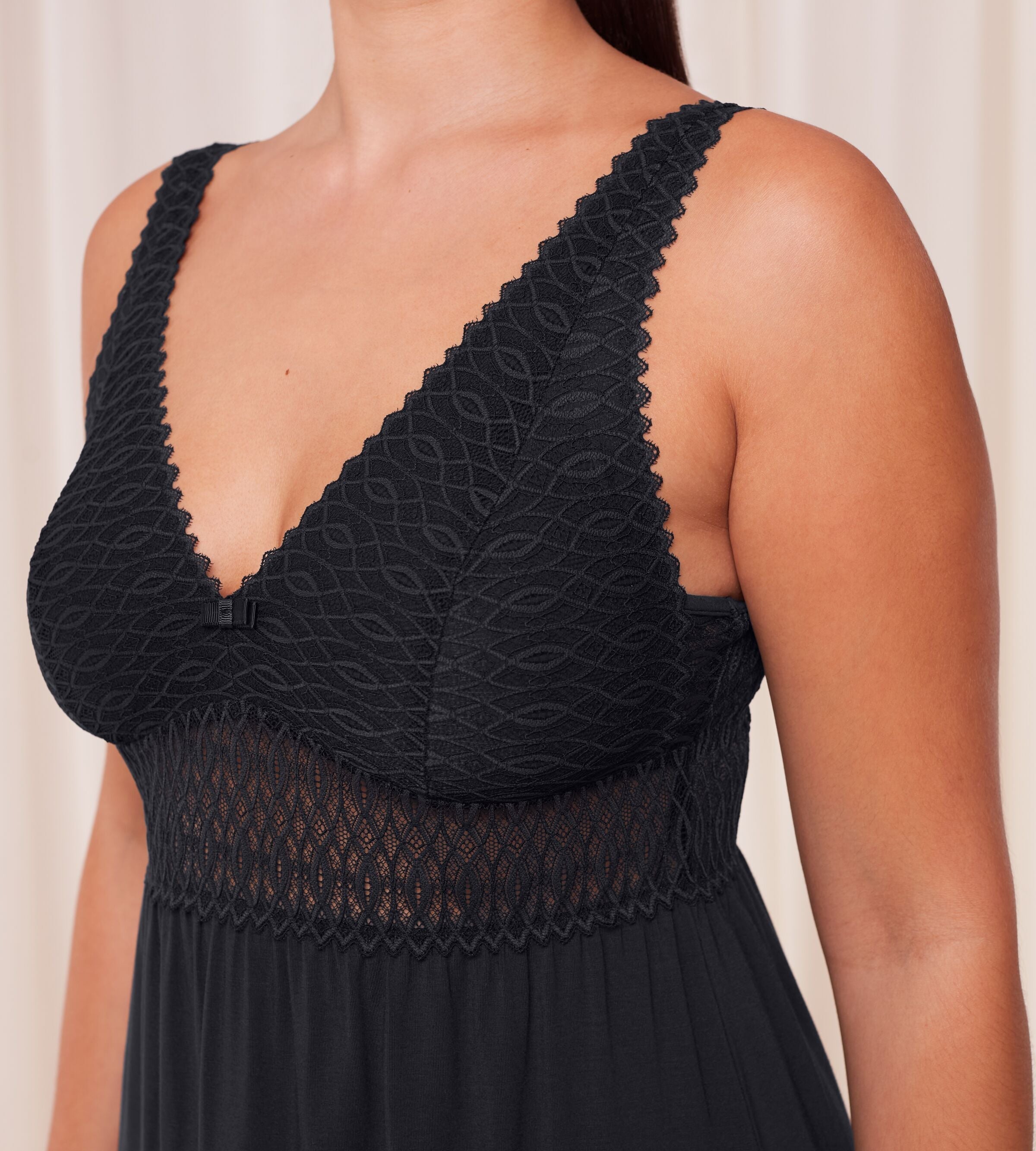Triumph Aura Spotlight nightdress in black model close-up side view, detailing lace-covered cups, a semi-sheer waistband. Shop Now Online