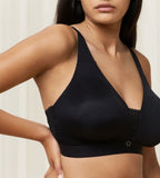 Triumph Aura Spotlight non-wired bra in black model close-up side view, showing fit and the comfortable wireless design. Find Now Online