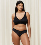 Triumph Aura Spotlight non-wired bra in black model full front view, showing the plunging lace neckline and comfortable wireless design. Find Now Online