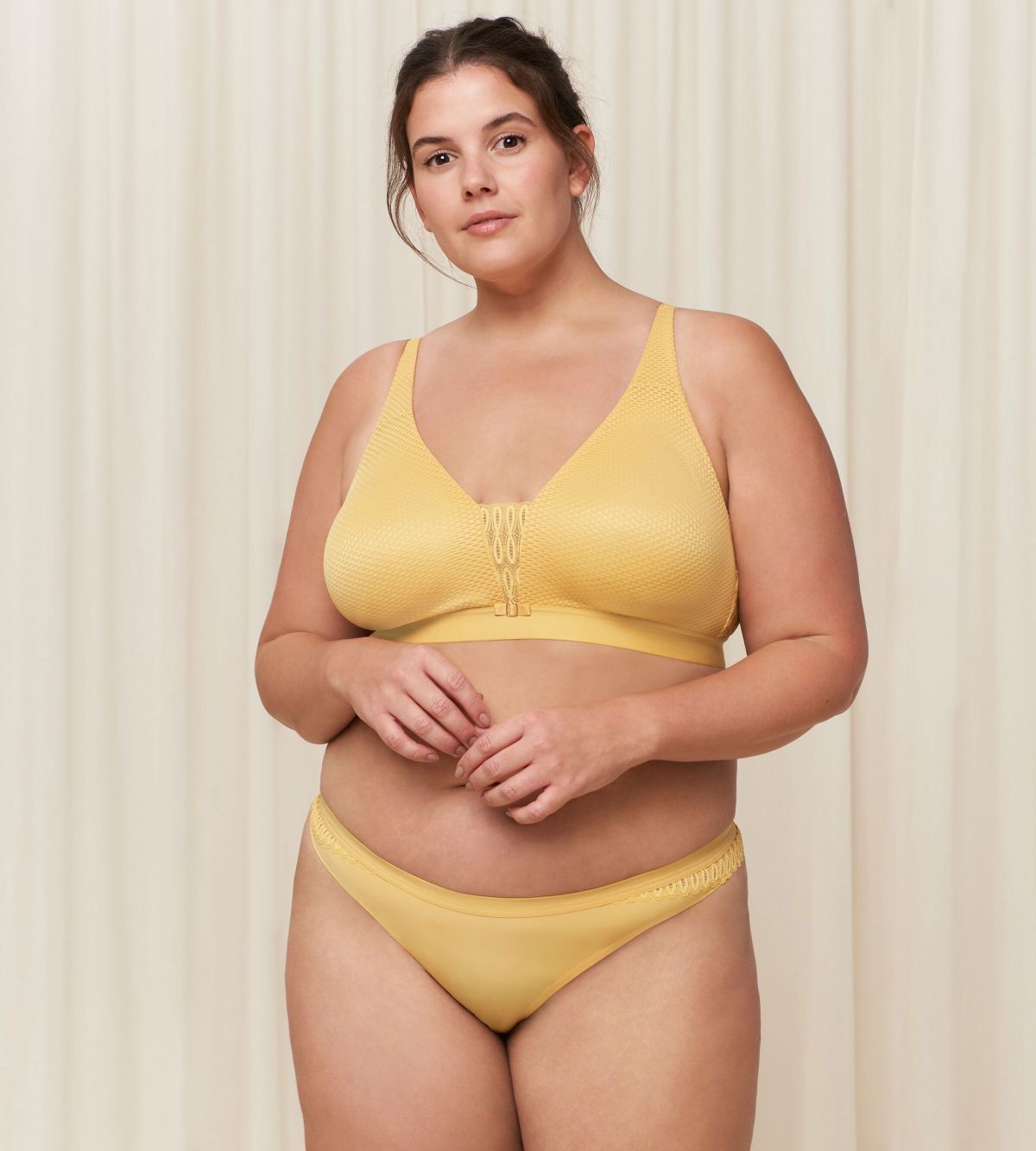 Triumph Aura Spotlight non-wired bra in yellow third model full front view, showcasing the vibrant floral lace and supportive wireless design. Shop the Latest Online