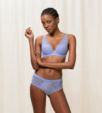 Triumph Aura Spotlight wired padded bra in Purple Dust model full front view, highlighting the lace-overlaid cups and comfortable underwire design. Shop the Latest Online.
