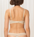 Triumph Aura Spotlight wired padded bra in light beige model back view, showing adjustable straps. Available Online