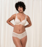 Triumph Aura Spotlight wired padded bra in light beige second model full front view, showing the lace-overlaid cups and comfortable underwired design. Available Online