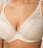 Triumph Aura Spotlight wired padded bra in light beige third model close-up view, showing details of the lace-overlaid cups and comfortable underwired design. Shop Now Online