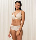 Triumph Aura Spotlight wired padded bra in light beige third model full front view, showing the lace-overlaid cups and comfortable underwired design. Shop Now Online