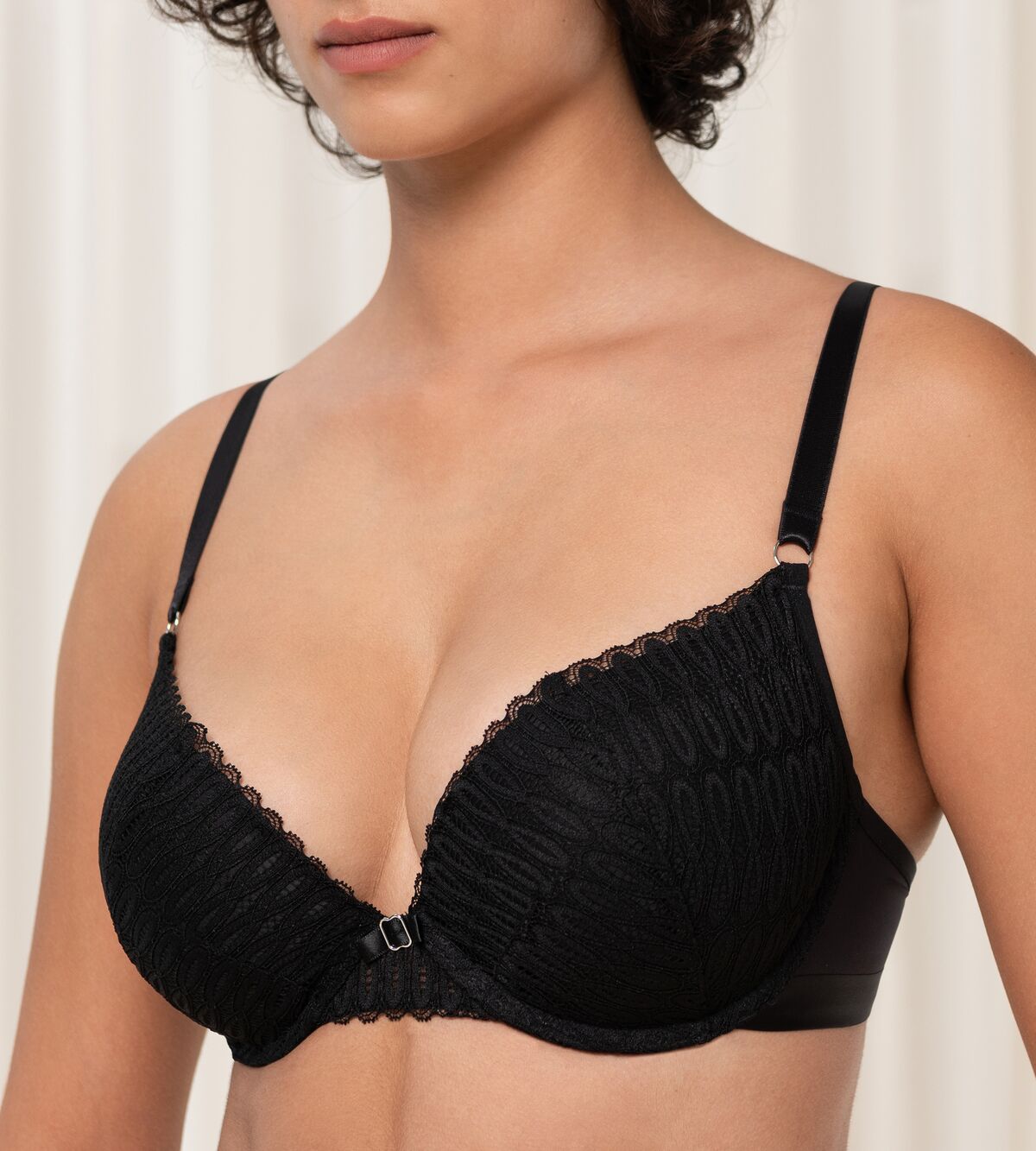 Triumph Aura Spotlight wired push-up bra in black model close-up view, highlighting the padded cups and elegant lace detailing. Order Online Today