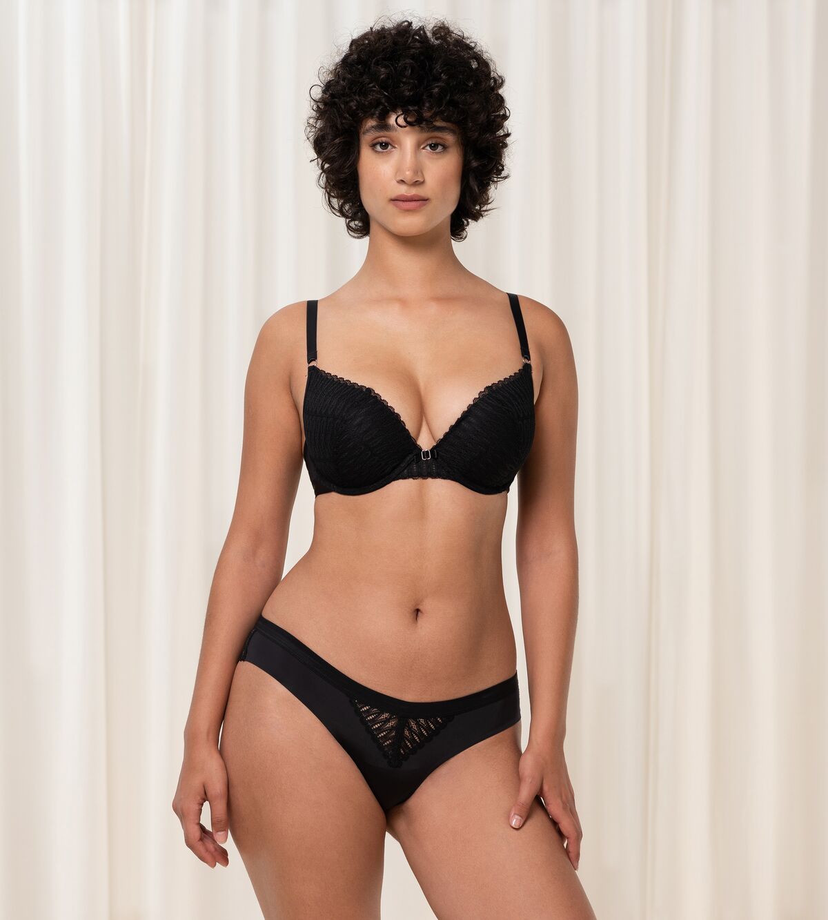 Triumph Aura Spotlight wired push-up bra in black model full front view, highlighting the padded cups and elegant lace detailing. Order Online Today
