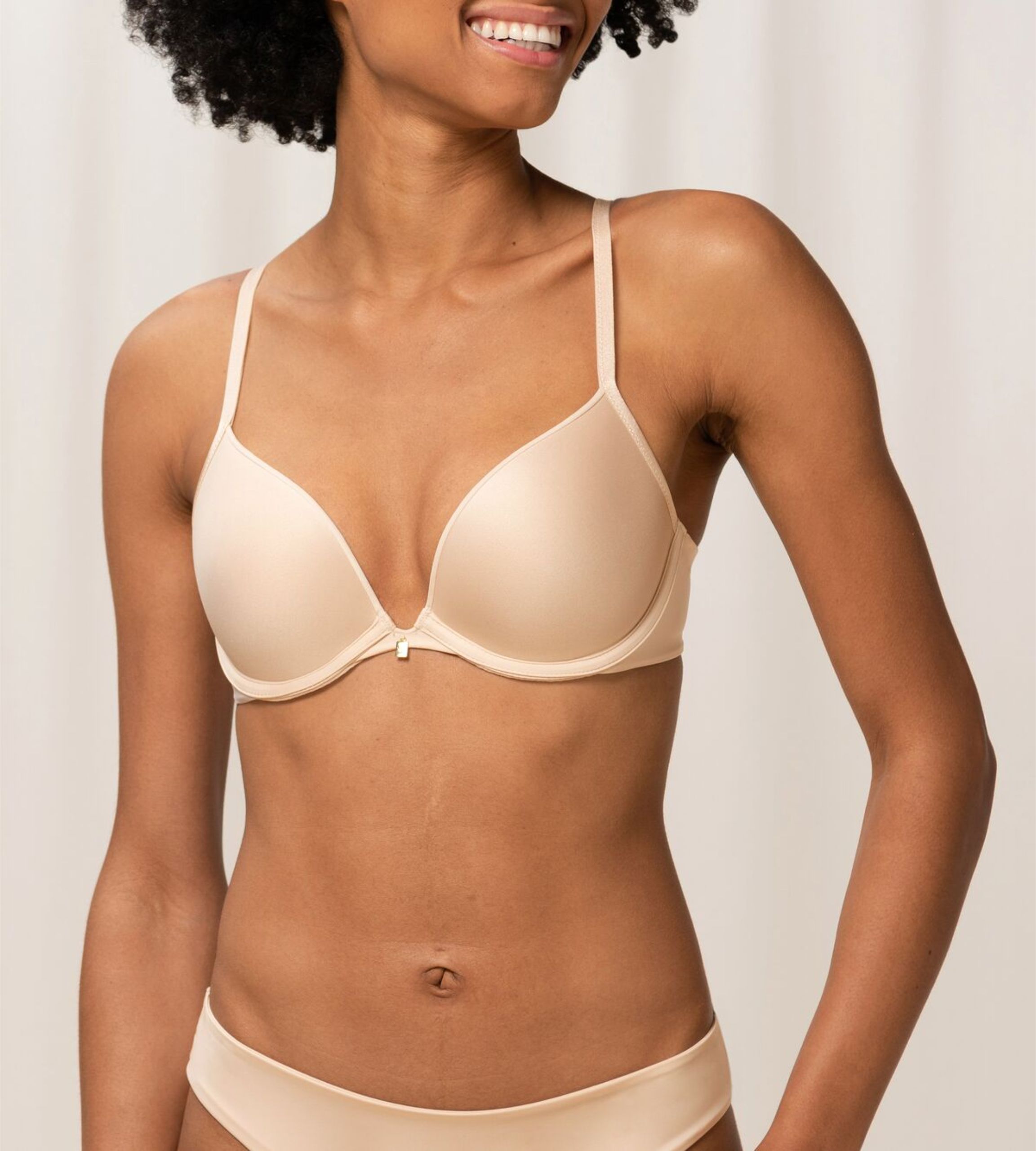 Triumph Body Make-Up Essentials nude beige push-up bra second model front view, showing the smooth padded cups and plunging neckline. Now Available Online