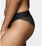 Triumph Body Make-Up Illusion Black lace tai panty model close-up side view, highlighting the high-cut leg and seamless lace finish. Available for Online Purchase