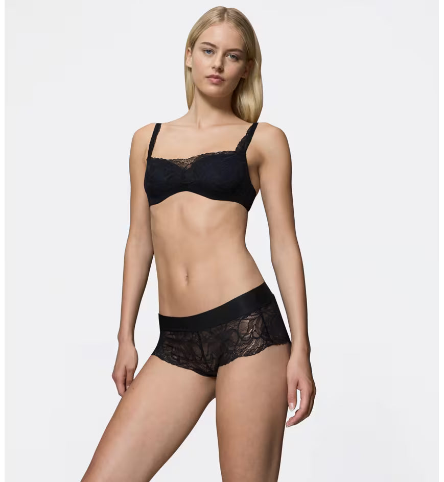 Triumph Body Make-Up Illusion black lace shorts panty model full front view, showcasing the floral lace and seamless waistband. Available Online at Blue Salon Qatar