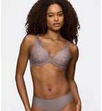 Triumph Body Make-Up Illusion lace grey wired padded bra model front view, showcasing the smooth  floral lace cups and plunge neckline. Find Online Today