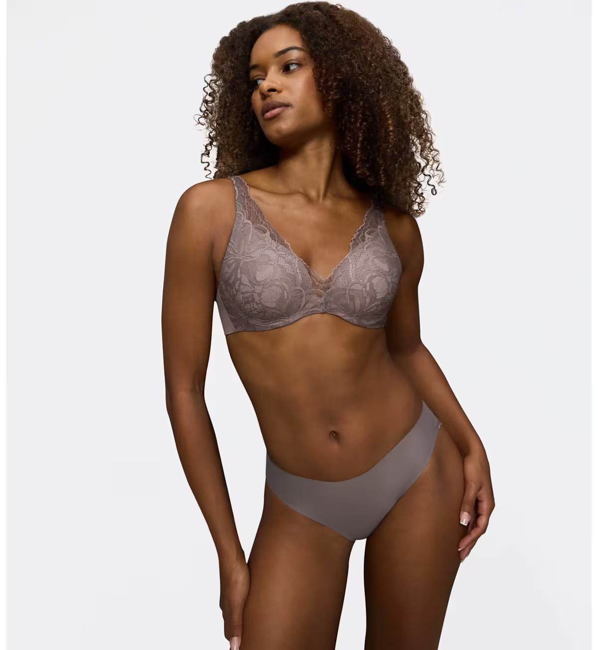 Triumph Body Make-Up Illusion lace grey wired padded bra model full front view, showcasing the smooth  floral lace cups and plunge neckline. Find Online Today