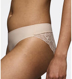 Triumph Body Make-Up Illusion lace nude beige tai panty model close-up side view, showing the seamless floral lace details. Shop Online Today