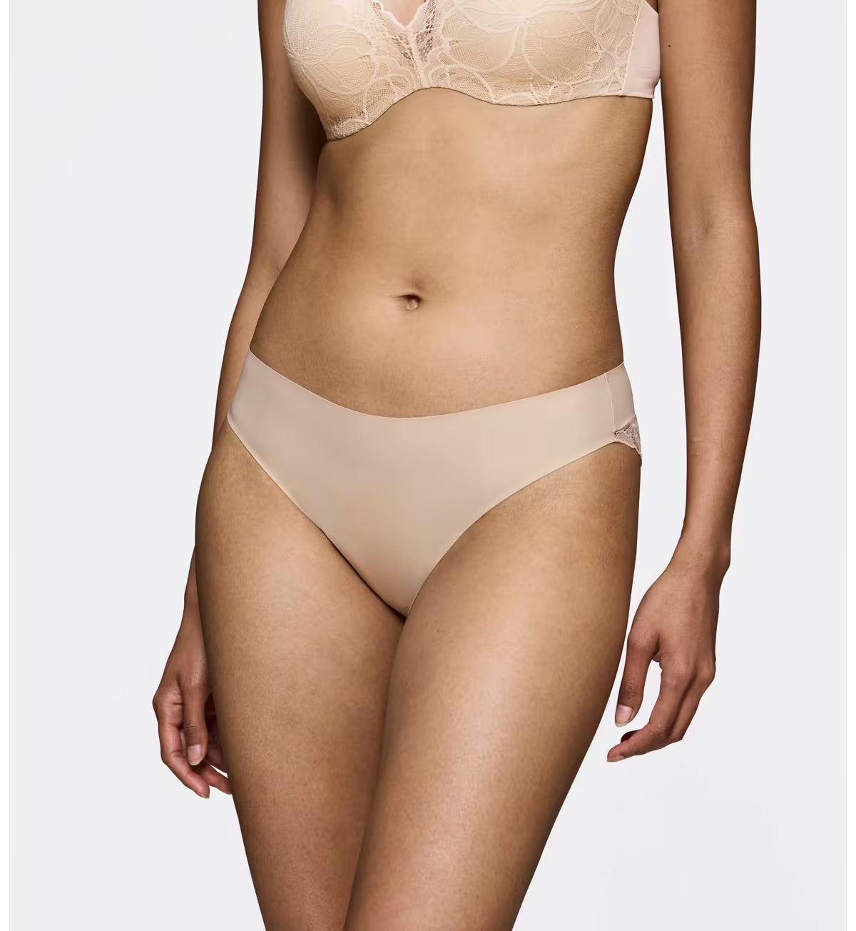 Triumph Body Make-Up Illusion lace nude beige tai panty model front view, showing the seamless floral lace details. Shop Online Today