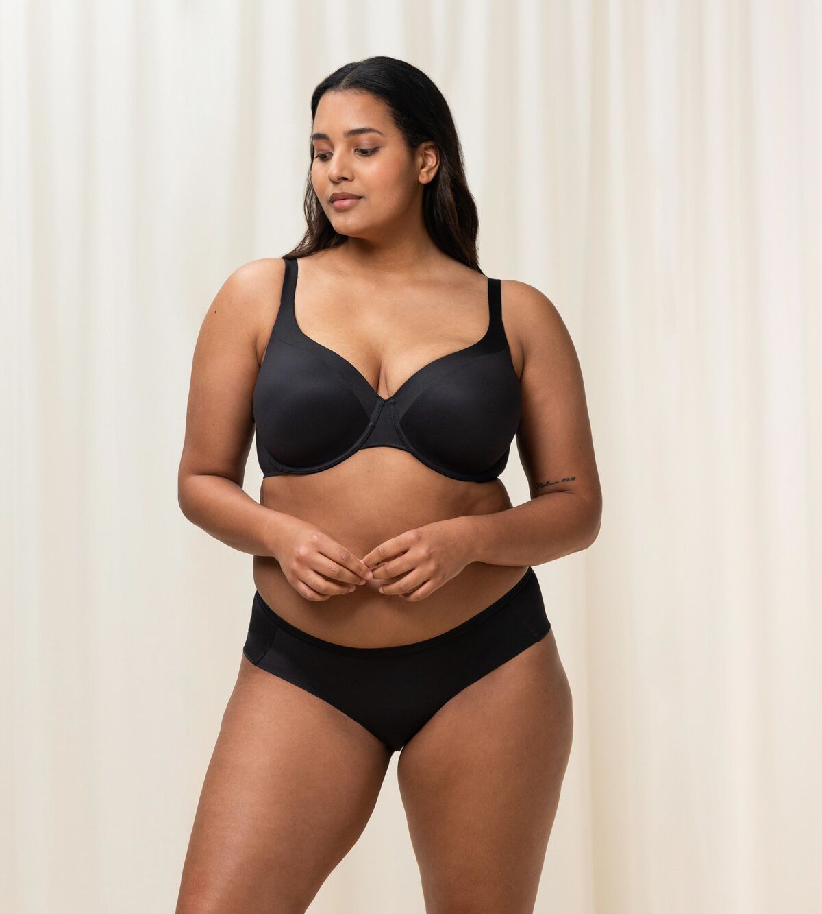 Triumph Body Make-Up Soft Touch black wired padded bra third model full front view, showing the smooth cups and comfortable strap design. Shop Online Today