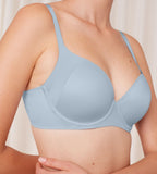 Triumph Body Make-Up Soft Touch light blue wired padded bra model close-up side view, highlighting the smooth cups and soft-touch fabric texture. Shop Now Online