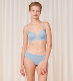 Triumph Body Make-Up Soft Touch light blue wired padded bra model full front view, highlighting the smooth cups and soft-touch fabric texture. Shop Now Online