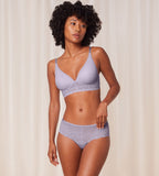 Triumph Bright Spotlight lilac hipster panty model full front view, showcasing the intricate floral lace and soft pastel color. Available Online at Blue Salon Qatar