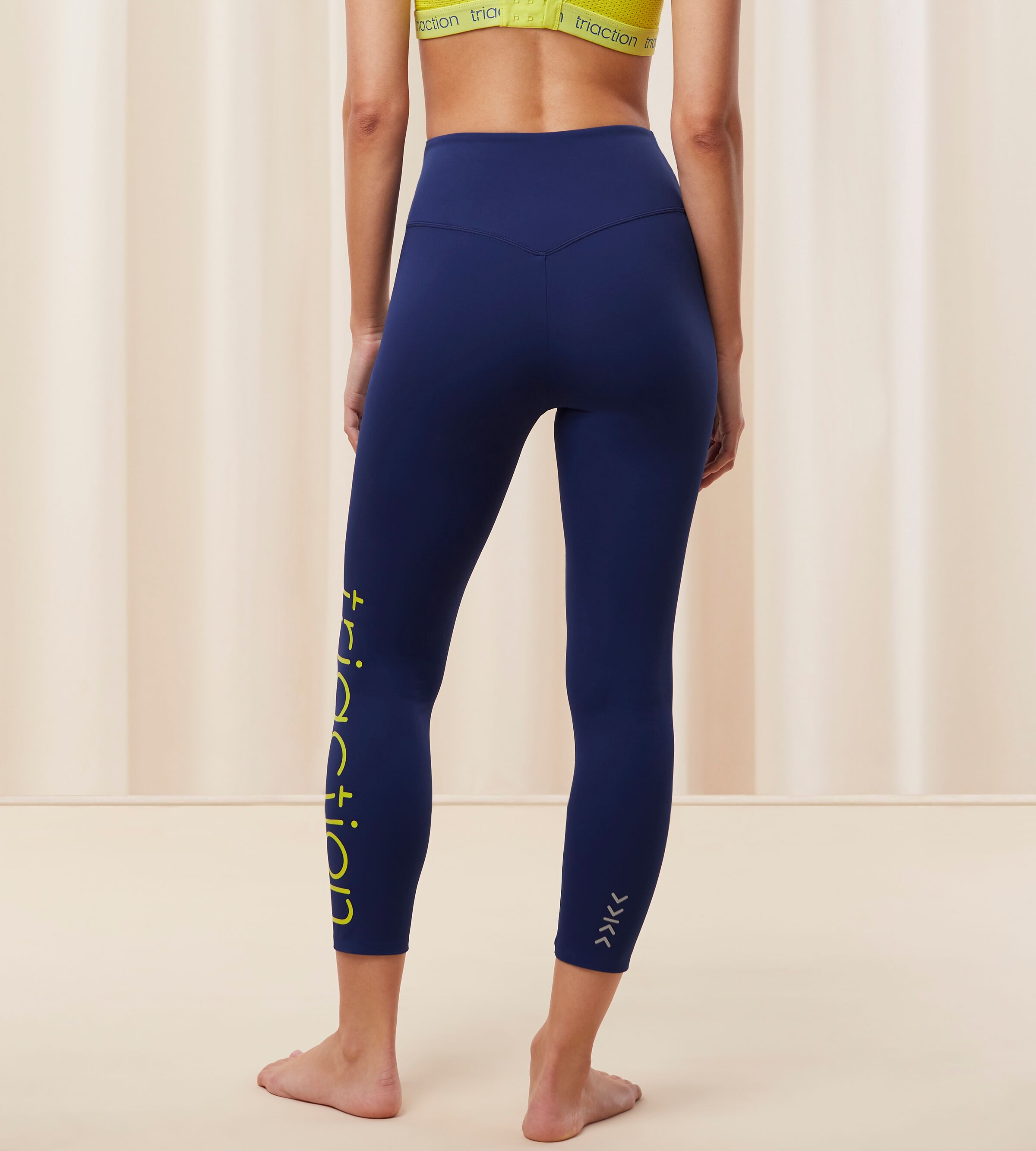 Triumph Cardio RTW high waist navy sports leggings model back view, showcasing the compressive fit and smooth performance texture. Find Online Today