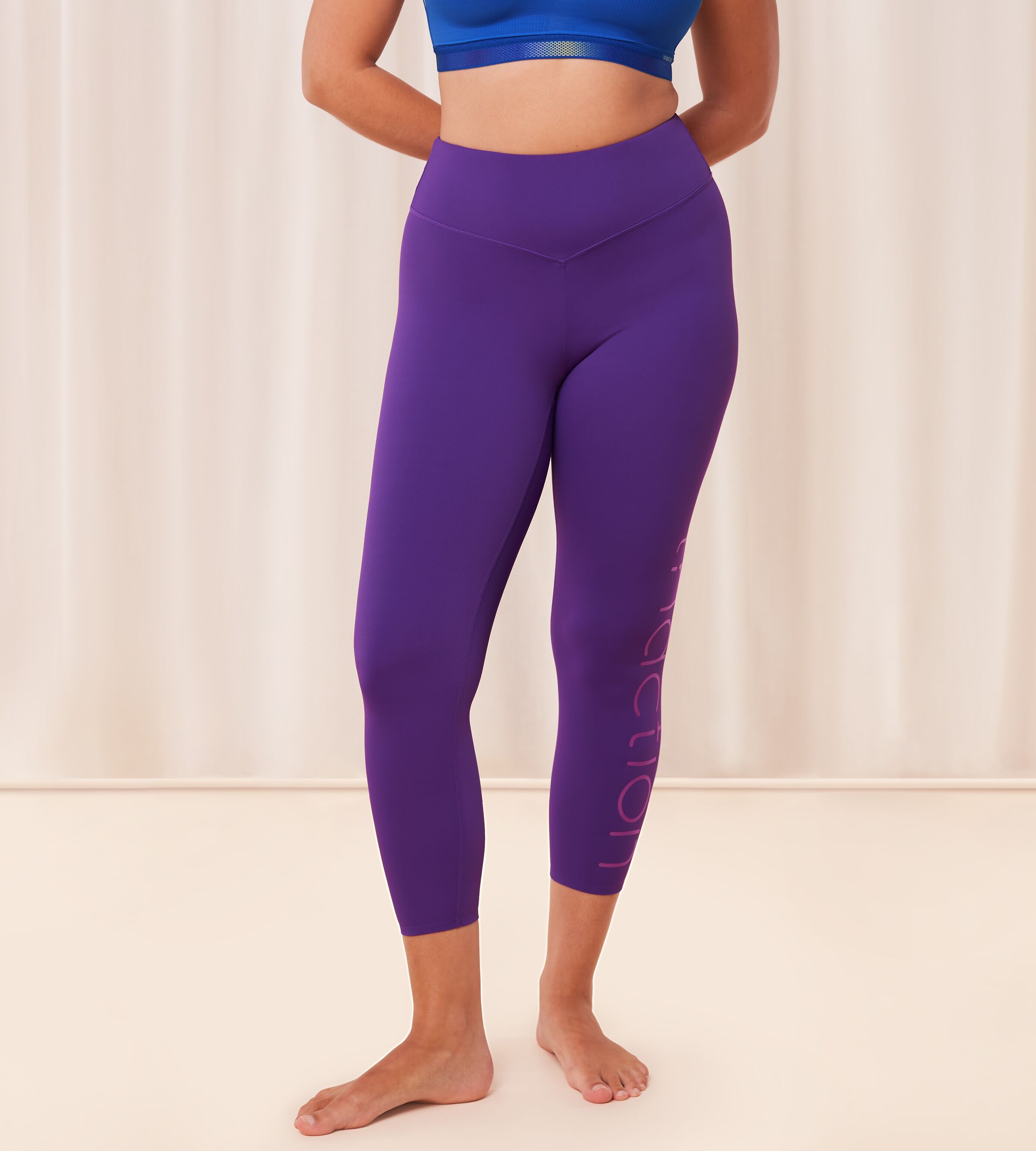 Triumph Cardio RTW high waist purple sports leggings model front view, showing the supportive waistband and sleek performance fabric. Available for Online Purchase