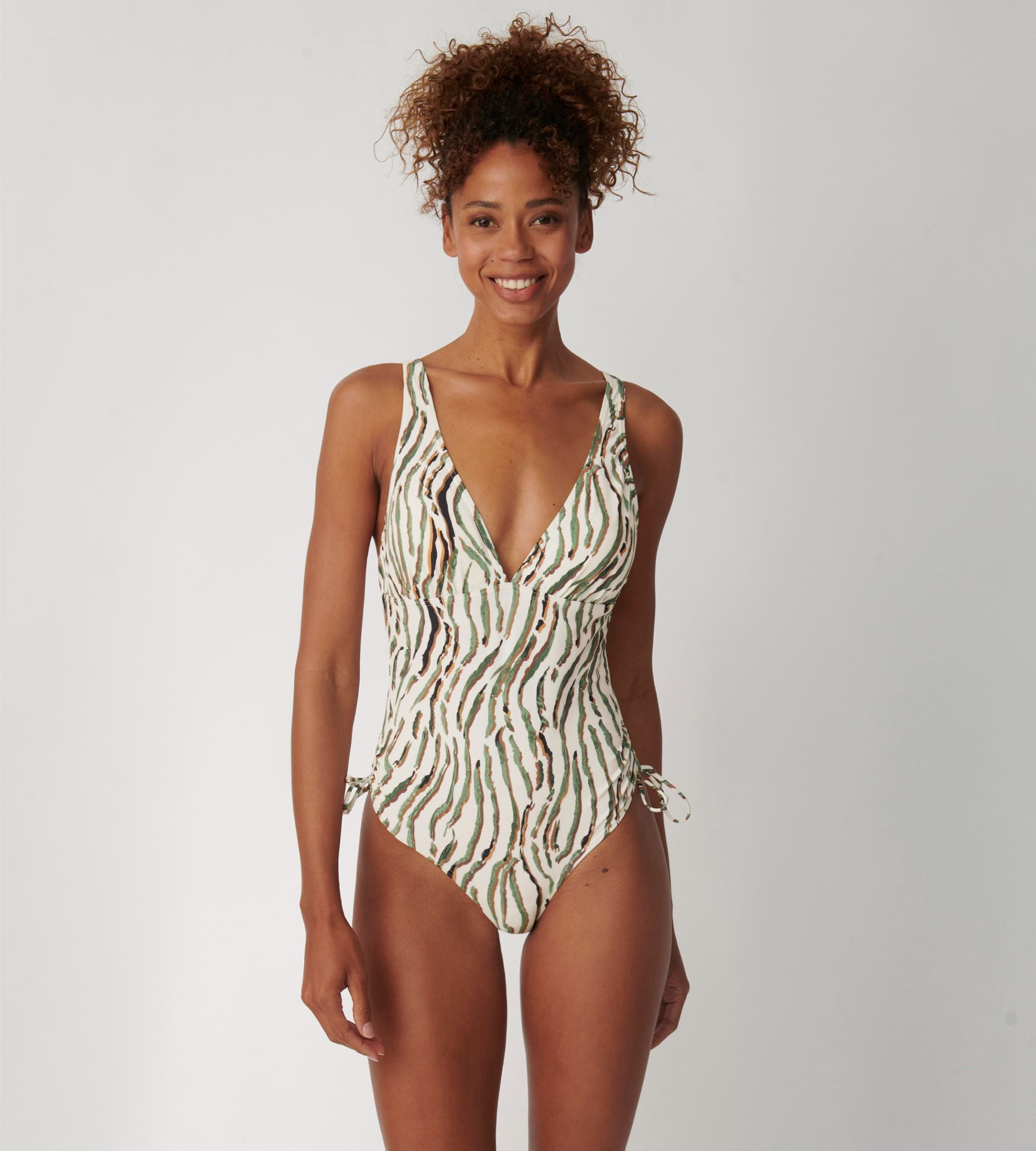 Triumph Charm Elegance 2.0 multicolored one-piece swimsuit model front view, highlighting the ruched front and elegant artistic print. Shop Online Today