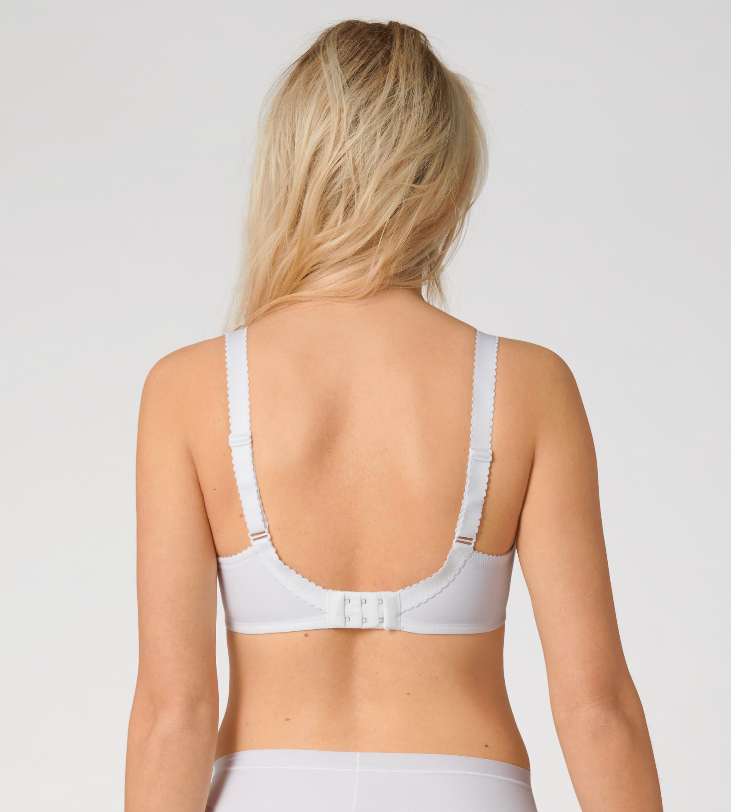 Triumph Delicate Doreen white non-wired bra model back view, highlighting the adjustable and supportive wide straps. Available Now Online