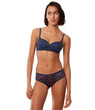 Triumph Delightful Spotlight dark blue hipster panty model full front view, showcasing the wide sides and intricate lace detailing. Available Online