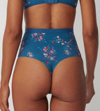 Triumph Electra Spotlight blue high waist thong model back view, highlighting the thong back and the floral mesh with high-waist silhouette. Available Online Today