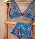 Triumph Electra Spotlight blue non-wired bra second product-only view, paired with panties, highlighting the triangle lace cups and deep blue color with floral design. Find Online Now