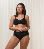 Triumph Essential Minimizer black underwired bra model full front view, showing the shimmering jacquard pattern and wide adjustable straps. Shop the Latest Online
