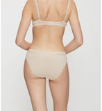 Triumph Feel Of Modal light beige tai panties model back view, highlighting the high-cut leg and decorative lace waistband. Order Online Today