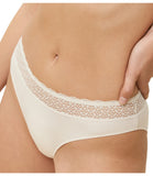 Triumph Feel Of Modal light beige tai panties model close-up view, highlighting the high-cut leg and decorative lace waistband. Order Online Today