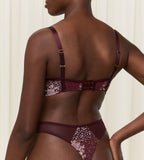 Triumph Lavish Spotlight burgundy wired padded bra second model back view, highlighting the detailed lace embroidery and the adjustable straps with back closure. Now Online at Blue Salon Qatar