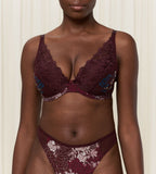 Triumph Lavish Spotlight burgundy wired padded bra second model front view, highlighting the detailed lace embroidery and elegant plunge fit. Now Online at Blue Salon Qatar