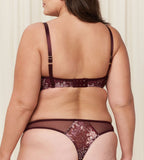 Triumph Lavish Spotlight burgundy wired padded bra third model back view, highlighting the detailed lace embroidery and the adjustable straps with back closure. Now Online at Blue Salon Qatar