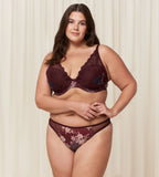 Triumph Lavish Spotlight burgundy wired padded bra third model full front view, highlighting the detailed lace embroidery and elegant plunge fit. Now Online at Blue Salon Qatar