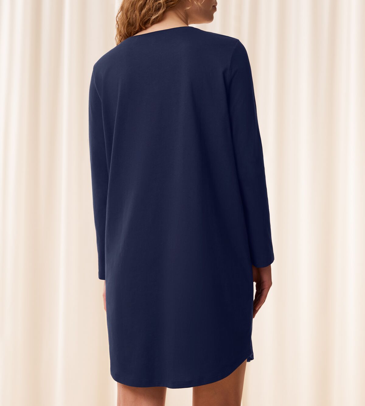Triumph Lounge-Me cotton navy long-sleeved nightdress model back view, with a round neckline and knee-length hem. Shop Now Online