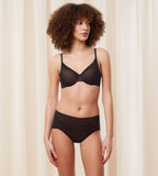 Triumph Signature sheer black maxi panty model full front view, with a geometric monogram pattern. Order Online Today
