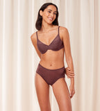 Triumph Signature sheer brown maxi panty model full front view, with a geometric monogram pattern. Available for online purchase
