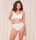 Triumph Signature sheer white maxi panty model full front view, showing fit with geometric monogram mesh. Available Online Now