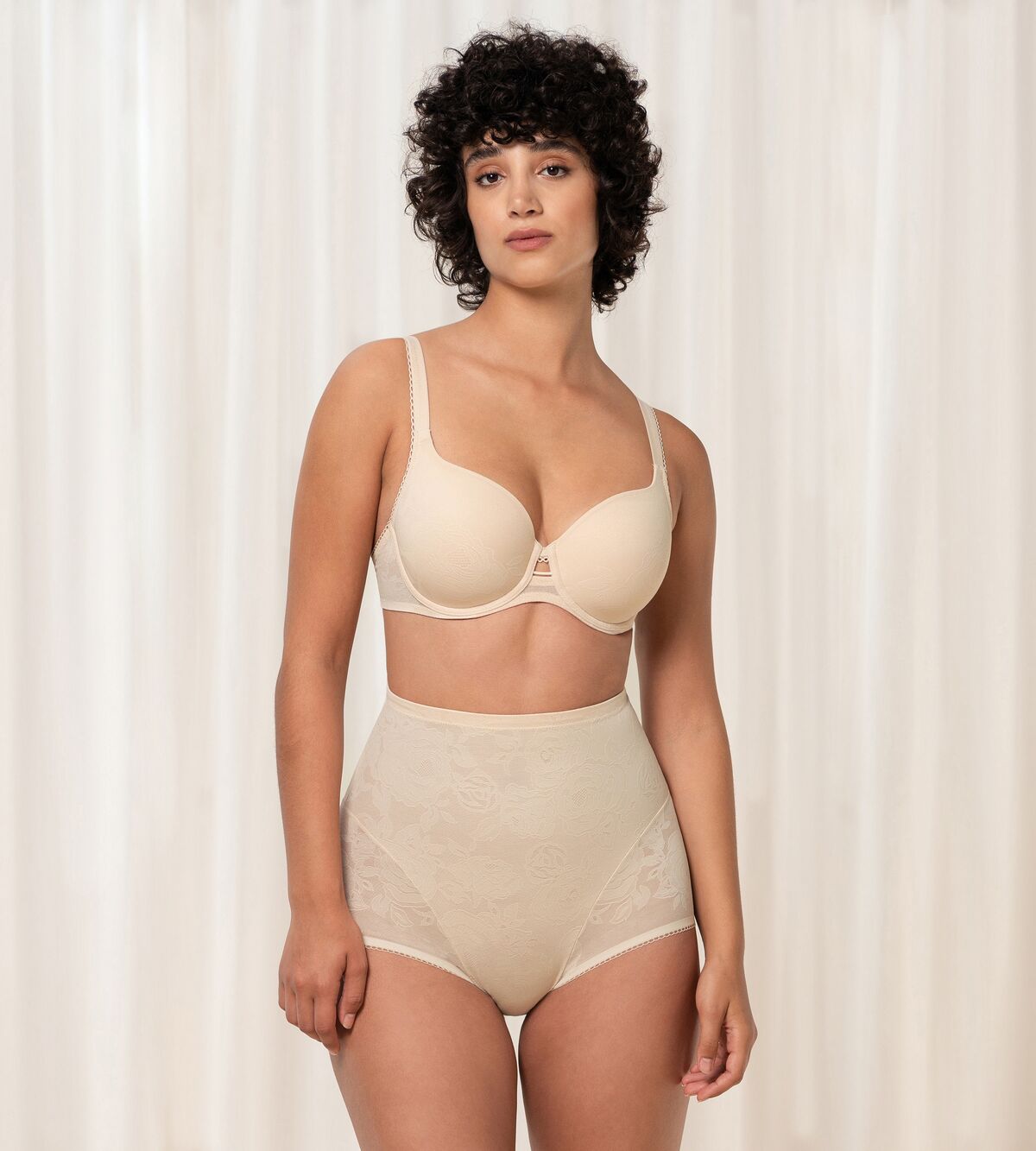 Triumph Wild Rose Sensation beige padded wired bra second model full front view, with floral lace pattern. Shop the latest online