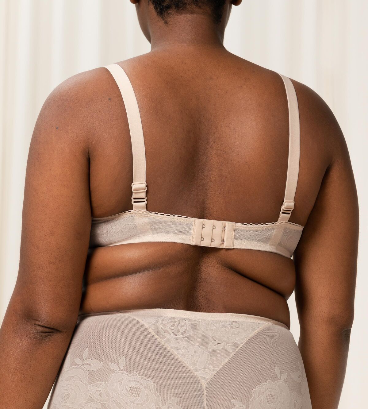 Triumph Wild Rose Sensation beige padded wired bra third model back view, with floral lace pattern and adjustable straps. Shop the latest online