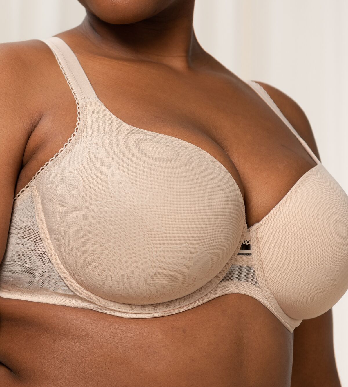 Triumph Wild Rose Sensation beige padded wired bra third model close-up side view, with floral lace pattern. Shop the latest online