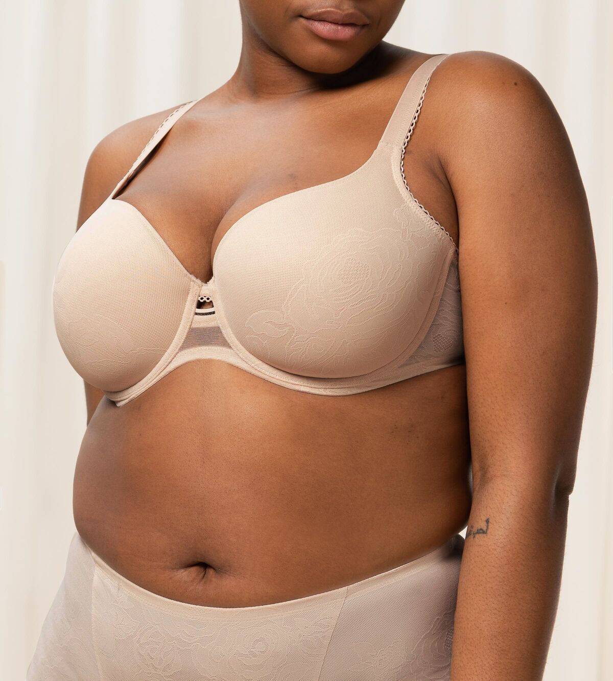 Triumph Wild Rose Sensation beige padded wired bra third model front view, with floral lace pattern. Shop the latest online