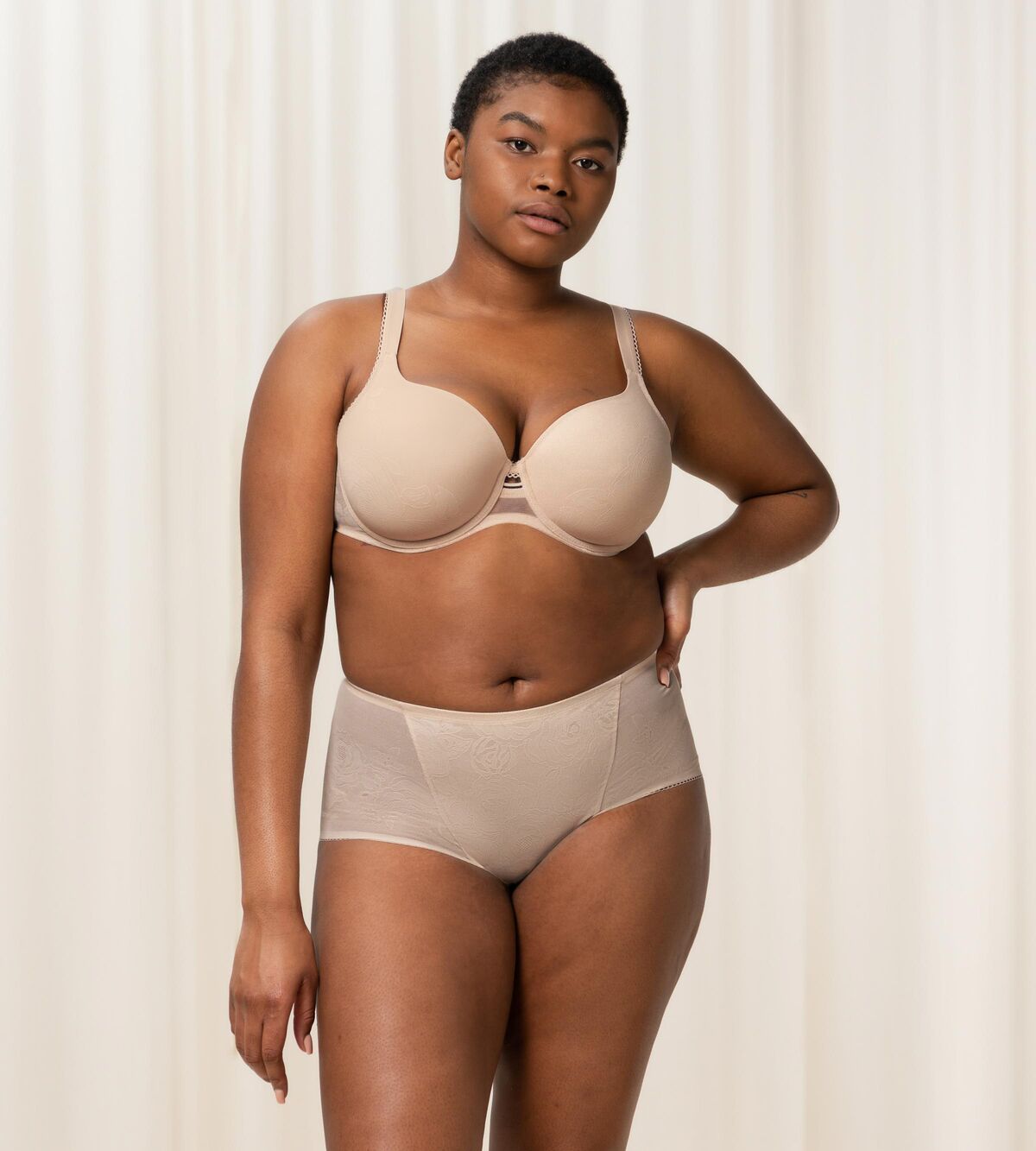 Triumph Wild Rose Sensation beige padded wired bra third model full front view, with floral lace pattern. Shop the latest online