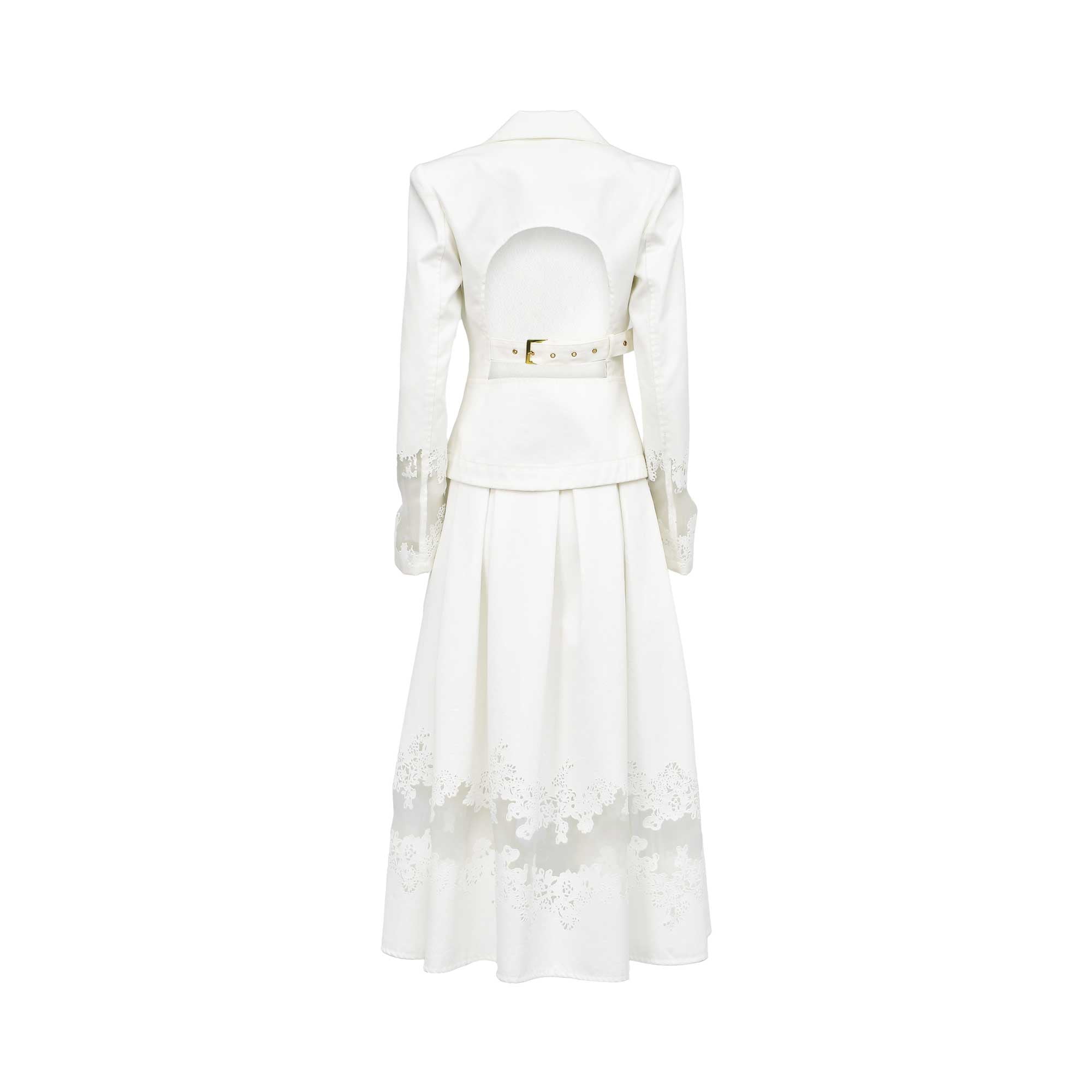 Back view of the Tuba Ergin off-white two-piece ensemble, highlighting a bold open cut-out back on the blazer held by a buckled waist strap, paired with a pleated maxi skirt featuring a sheer lace-embroidered hem.