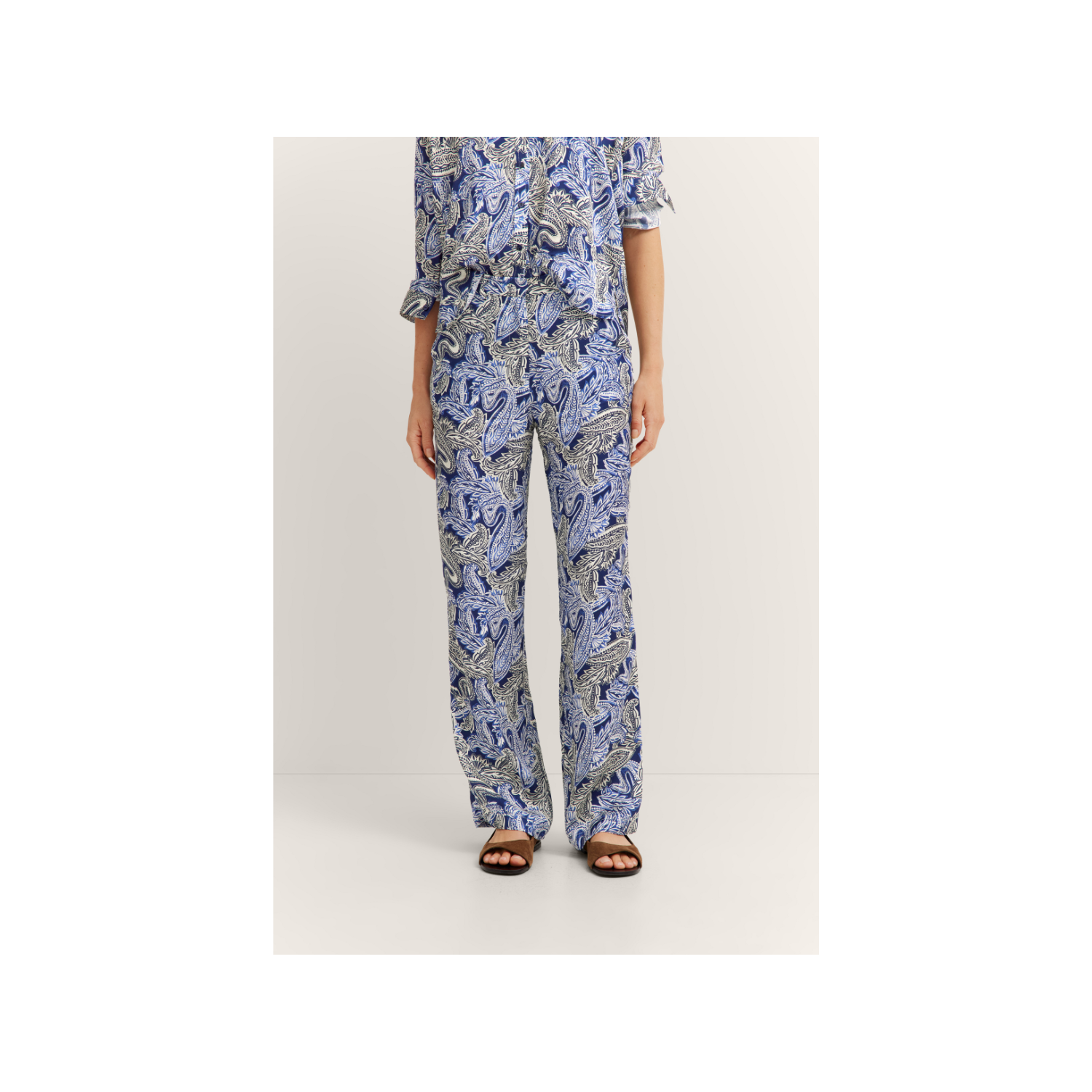 Navy blue, light blue, and white paisley print wide-leg trousers with an elasticated waistband.